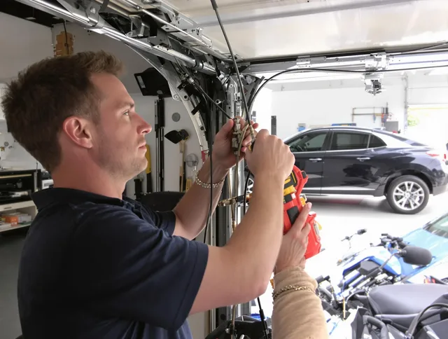 Clearwater Garage Door Repair safety certified technician performing cable replacement in Clearwater
